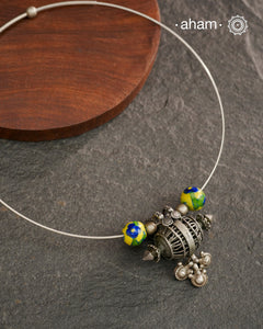 Beautiful silver hasli with a vintage looking pendant along with jaipur blue pottery beads. Easy to wear, looks great with Indian and Western outfits. The Hasli is easily removable and can be used with any other pendant as well.&nbsp;