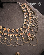 This Tribal Glass Silver Neckpiece showcases exquisite craftsmanship inspired by traditional designs from Rajasthan and Uttar Pradesh. Set in sterling silver, the vibrant glass elements highlight the rich cultural heritage of these regions. Perfect for adding an authentic ethnic touch to your collection, this neckpiece combines artistry with timeless elegance.