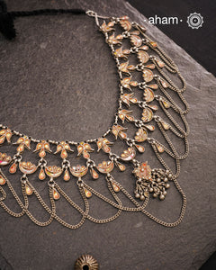 This Tribal Glass Silver Neckpiece showcases exquisite craftsmanship inspired by traditional designs from Rajasthan and Uttar Pradesh. Set in sterling silver, the vibrant glass elements highlight the rich cultural heritage of these regions. Perfect for adding an authentic ethnic touch to your collection, this neckpiece combines artistry with timeless elegance.