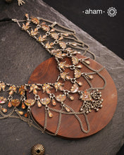 This Tribal Glass Silver Neckpiece showcases exquisite craftsmanship inspired by traditional designs from Rajasthan and Uttar Pradesh. Set in sterling silver, the vibrant glass elements highlight the rich cultural heritage of these regions. Perfect for adding an authentic ethnic touch to your collection, this neckpiece combines artistry with timeless elegance.