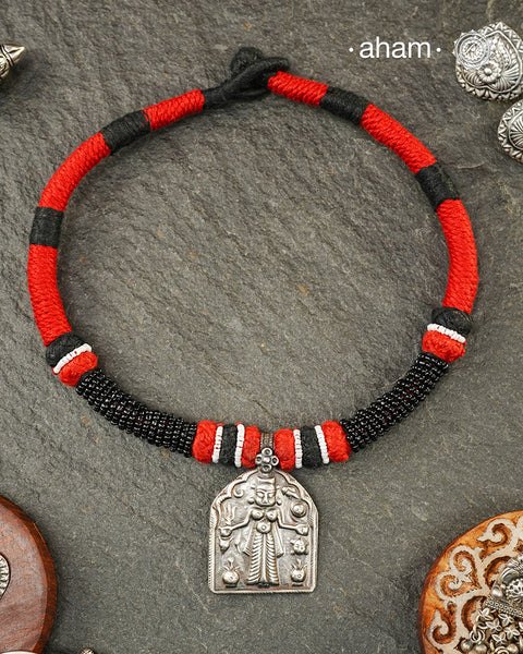 Discover the charm of traditional craftsmanship with our Handmade Karni Devi Mata 92.5 Sterling Silver Pendant on a beautiful cotton cord.&nbsp;
Expertly crafted using the thapi (stamp die) technique, this pendant reflects the age-old artistry of India’s tribal communities. Known by various names like Kavach, Mandaliya, Patri, and Kathla, amulet pendants have long been cherished as symbols of passive worship—a way to keep your deity, Kuldevta, or Kuldevi close to your heart. 