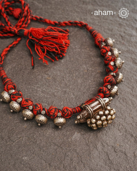 Tribal Silver Neckpiece with adjustable thread.Traditional ghungroo amulet and beautiful trinket silver beads have been given a new twist by threading them into a beautiful unique short neckpiece. A perfect, unique piece to wear with your ethnic wear.