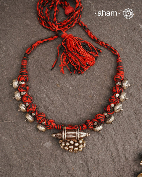 Tribal Silver Neckpiece with adjustable thread.Traditional ghungroo amulet and beautiful trinket silver beads have been given a new twist by threading them into a beautiful unique short neckpiece. A perfect, unique piece to wear with your ethnic wear.