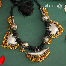Elevate your style with this Tribal Two Tone Silver Neckpiece, featuring a captivating amulet center framed by elegant paan-shaped beads. The gold-dipped ghungroos add a stunning dual-tone contrast, making this piece truly one-of-a-kind. Perfect for those who want to make a bold cultural statement while embracing exquisite craftsmanship. Don’t miss the chance to own a unique accessory.