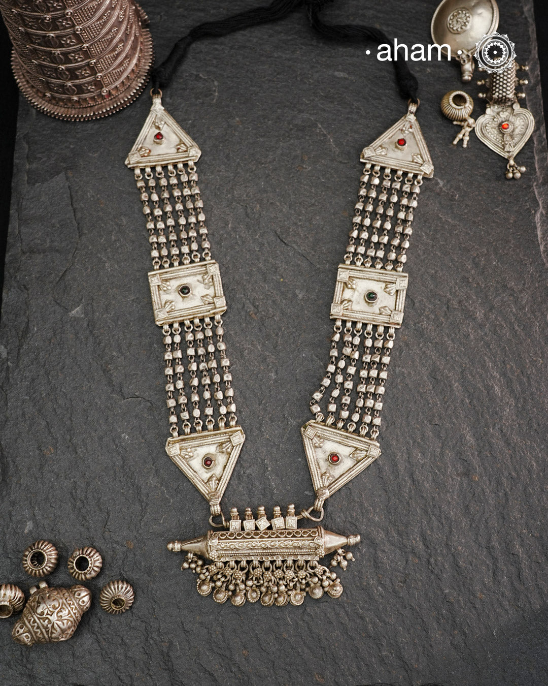 This tribal silver neckpiece features an amulet pendant and traditional side belts, reflecting the rich heritage of Rajasthan and Gujarat. Crafted entirely in silver, it offers a unique blend of cultural artistry and timeless elegance. Perfect for those who appreciate authentic, handcrafted jewellery with a meaningful story.