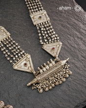 This tribal silver neckpiece features an amulet pendant and traditional side belts, reflecting the rich heritage of Rajasthan and Gujarat. Crafted entirely in silver, it offers a unique blend of cultural artistry and timeless elegance. Perfect for those who appreciate authentic, handcrafted jewellery with a meaningful story.