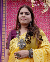 This Tribal Silver Neckpiece from Gujarat embodies the rich heritage of the Rabari community in the Kutch region. Featuring a distinctive arrowhead amulet pendant (chagda) flanked by traditional amulet chains (madaliya), this handcrafted silver piece carries generations of cultural significance. Wearing it connects you to timeless traditions while adding a unique, authentic touch to your style.