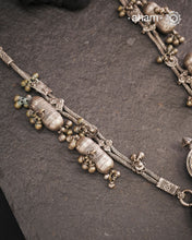 This Tribal Silver Neckpiece from Gujarat embodies the rich heritage of the Rabari community in the Kutch region. Featuring a distinctive arrowhead amulet pendant (chagda) flanked by traditional amulet chains (madaliya), this handcrafted silver piece carries generations of cultural significance. Wearing it connects you to timeless traditions while adding a unique, authentic touch to your style.