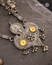 This Tribal Silver Neckpiece from Gujarat embodies the rich heritage of the Rabari community in the Kutch region. Featuring a distinctive arrowhead amulet pendant (chagda) flanked by traditional amulet chains (madaliya), this handcrafted silver piece carries generations of cultural significance. Wearing it connects you to timeless traditions while adding a unique, authentic touch to your style.