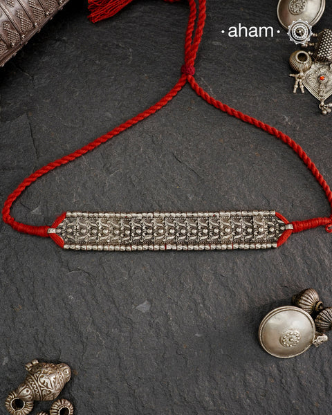 This Tribal Lotus Silver Choker exemplifies the refined craftsmanship of Orissa, skillfully handcrafted in pure silver. Featuring a stunning lotus motif, it embodies traditional artistry with a contemporary appeal. Perfect for those who value expert design and cultural heritage, this choker enhances any outfit with its elegant and distinctive presence.