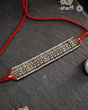 This Tribal Lotus Silver Choker exemplifies the refined craftsmanship of Orissa, skillfully handcrafted in pure silver. Featuring a stunning lotus motif, it embodies traditional artistry with a contemporary appeal. Perfect for those who value expert design and cultural heritage, this choker enhances any outfit with its elegant and distinctive presence.