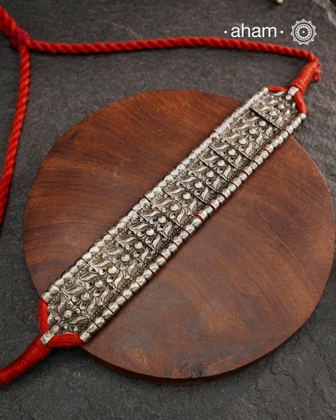 This Tribal Lotus Silver Choker exemplifies the refined craftsmanship of Orissa, skillfully handcrafted in pure silver. Featuring a stunning lotus motif, it embodies traditional artistry with a contemporary appeal. Perfect for those who value expert design and cultural heritage, this choker enhances any outfit with its elegant and distinctive presence.