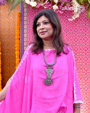 This Tribal Silver Neckpiece showcases a unique vintage buckle pendant sourced from the Rajasthan/Gujarat region, paired with a cluster of traditional ghungroos. The hand-woven silver chain adds intricate craftsmanship, making this statement piece a remarkable blend of heritage and artistry. Perfect for those who appreciate authentic, handcrafted silver jewellery with cultural significance.