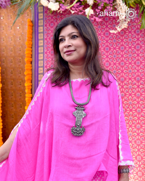 This Tribal Silver Neckpiece showcases a unique vintage buckle pendant sourced from the Rajasthan/Gujarat region, paired with a cluster of traditional ghungroos. The hand-woven silver chain adds intricate craftsmanship, making this statement piece a remarkable blend of heritage and artistry. Perfect for those who appreciate authentic, handcrafted silver jewellery with cultural significance.