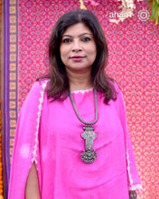 This Tribal Silver Neckpiece showcases a unique vintage buckle pendant sourced from the Rajasthan/Gujarat region, paired with a cluster of traditional ghungroos. The hand-woven silver chain adds intricate craftsmanship, making this statement piece a remarkable blend of heritage and artistry. Perfect for those who appreciate authentic, handcrafted silver jewellery with cultural significance.