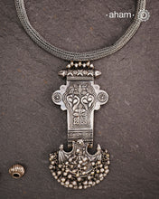 This Tribal Silver Neckpiece showcases a unique vintage buckle pendant sourced from the Rajasthan/Gujarat region, paired with a cluster of traditional ghungroos. The hand-woven silver chain adds intricate craftsmanship, making this statement piece a remarkable blend of heritage and artistry. Perfect for those who appreciate authentic, handcrafted silver jewellery with cultural significance.