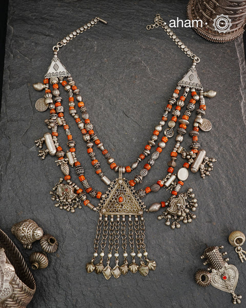 This Tribal Coral Silver Neckpiece draws inspiration from the rich heritage of Yemen’s traditional jewelry. Expertly crafted in silver, it combines vintage elements with carefully selected coral beads to create a unique, timeless piece. The blend of old and new beads offers a distinctive aesthetic that honours cultural artistry while providing a refined accessory for contemporary wear.