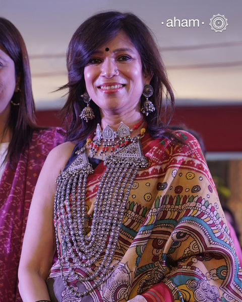 This Tribal Multi Line Silver Neckpiece is a magnificent classic Rani haar featuring seven intricately crafted lines, known as Satlada. It is adorned with a delicate floral pattern and accented by two prominent triangular motifs at each end. This vintage design exudes timeless elegance and cultural richness, making it a treasured heirloom piece meant to be passed down through generations. A neckpiece truly fit for a queen.