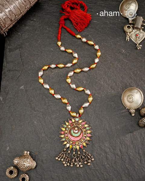 Long silver neckpiece made by putting together unique vintage tribal silver glass piece with a silver drop. Looks great when paired with workwear kurtas, saris or even a shirt.