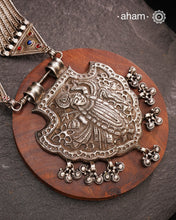 For those seeking a bold and striking accessory, the Shrenathji Tribal Silver Neckpiece is an exceptional choice. It features a large Shrinathji pendant, meticulously recreated from a vintage museum piece, complemented by side neckpiece bands characteristic of Jaisalmer craftsmanship. This piece is designed for women who appreciate distinctive, statement-making jewellery rooted in rich cultural heritage.