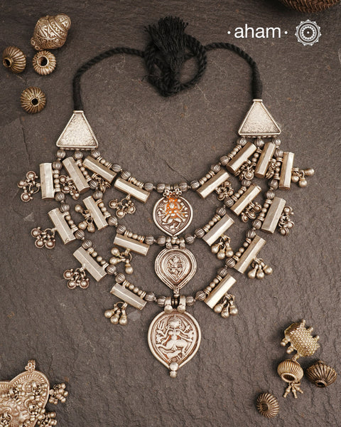 The Tribal Three Line Silver Neckpiece is expertly crafted with three layered strands, each featuring multiple finely detailed silver amulets. Made from silver, this piece combines traditional tribal design elements with meticulous craftsmanship, delivering an elegant accessory that adds cultural richness and sophistication to any outfit.