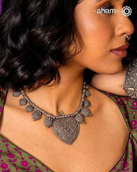 This expertly crafted Tribal Silver Neckpiece is a striking example of fine Orissa artisanship. Featuring intricately detailed silver pineapple pendants—known as 