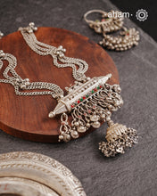 This tribal silver neckpiece features an amulet pendant and traditional side belts, reflecting the rich heritage of Rajasthan and Gujarat. Crafted entirely in silver, it offers a unique blend of cultural artistry and timeless elegance. Perfect for those who appreciate authentic, handcrafted jewellery.