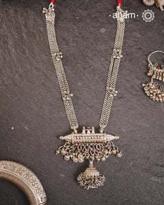 This tribal silver neckpiece features an amulet pendant and traditional side belts, reflecting the rich heritage of Rajasthan and Gujarat. Crafted entirely in silver, it offers a unique blend of cultural artistry and timeless elegance. Perfect for those who appreciate authentic, handcrafted jewellery.