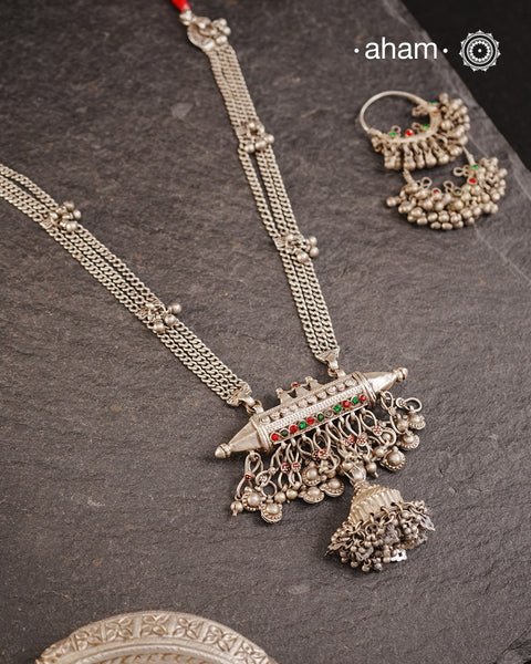 This tribal silver neckpiece features an amulet pendant and traditional side belts, reflecting the rich heritage of Rajasthan and Gujarat. Crafted entirely in silver, it offers a unique blend of cultural artistry and timeless elegance. Perfect for those who appreciate authentic, handcrafted jewellery.