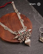 This tribal silver neckpiece features an amulet pendant and traditional side belts, reflecting the rich heritage of Rajasthan and Gujarat. Crafted entirely in silver, it offers a unique blend of cultural artistry and timeless elegance. Perfect for those who appreciate authentic, handcrafted jewellery.
