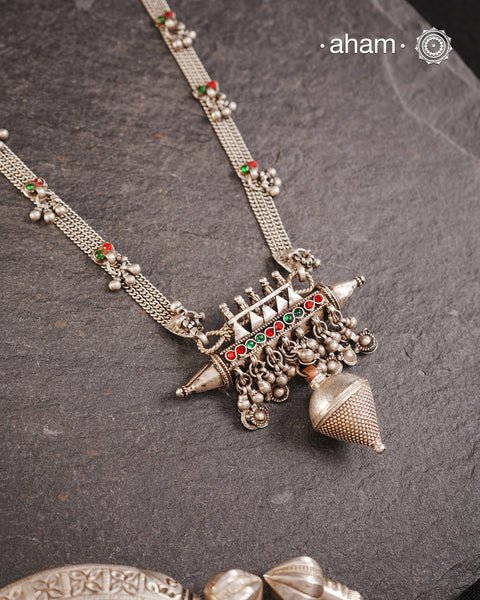 This tribal silver neckpiece features an amulet pendant and traditional side belts, reflecting the rich heritage of Rajasthan and Gujarat. Crafted entirely in silver, it offers a unique blend of cultural artistry and timeless elegance. Perfect for those who appreciate authentic, handcrafted jewellery.