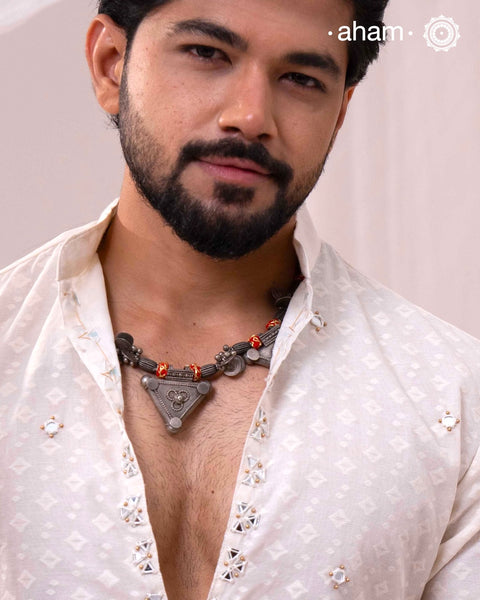 Handcrafted with precision, this Tribal Silver Neckpiece weaves together multiple tribal amulets and beads, embodying the seamless continuity of traditional design. Each element resonates with cultural significance, creating a distinguished piece that honors heritage through exceptional craftsmanship.