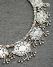 A beautiful Vintage neckpiece with nines geometric units with floral patterns interspersed with Melon shaped beads. We see a reference of this neckpiece in the book Traditional Jewellery of India by Opi Untracht.&nbsp;