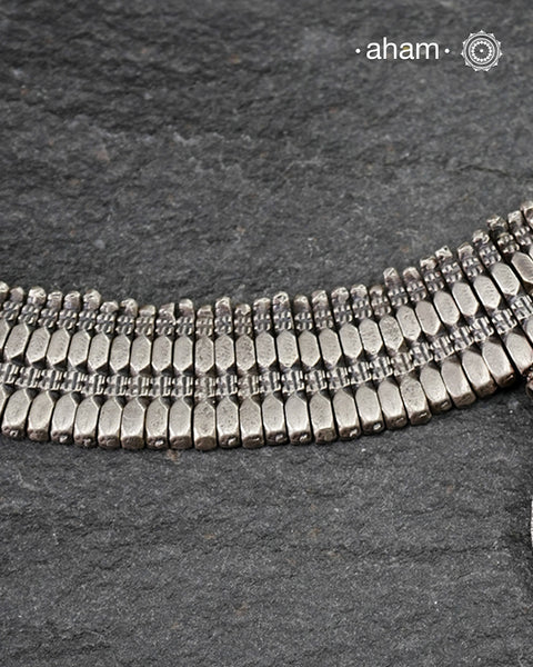 This Tribal Silver Neckpiece combines unique tribal elements, meticulously handcrafted in silver to create a one-of-a-kind statement accessory. Its distinct design highlights traditional craftsmanship, offering both cultural richness and timeless elegance for those who appreciate expert artistry.