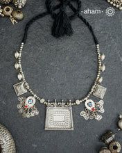 This Tribal Silver Neckpiece combines unique tribal elements, meticulously handcrafted in silver to create a one-of-a-kind statement accessory. Its distinct design highlights traditional craftsmanship, offering both cultural richness and timeless elegance.