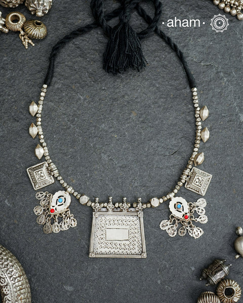 This Tribal Silver Neckpiece combines unique tribal elements, meticulously handcrafted in silver to create a one-of-a-kind statement accessory. Its distinct design highlights traditional craftsmanship, offering both cultural richness and timeless elegance.