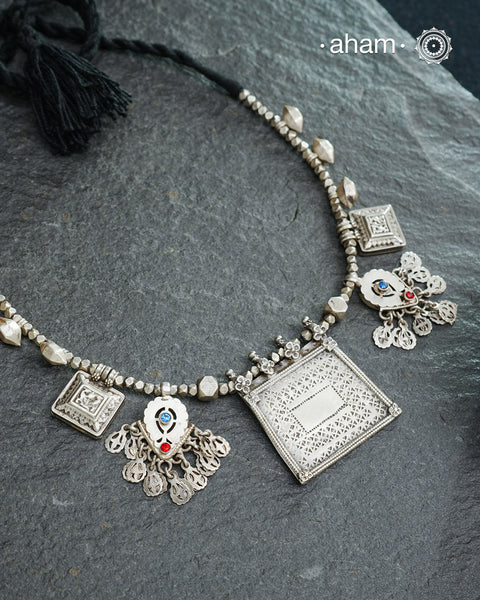This Tribal Silver Neckpiece combines unique tribal elements, meticulously handcrafted in silver to create a one-of-a-kind statement accessory. Its distinct design highlights traditional craftsmanship, offering both cultural richness and timeless elegance.