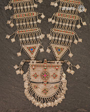 An extraordinary statement piece, this elaborate silver necklace brings together the bold geometry, vivid colour and intricate metalwork associated with the jewellery traditions of Afghanistan.