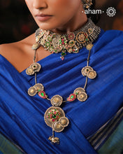 Handcrafted with love this noori dual tone neckpiece is a meticulous mix of royalty and artistry. Shine brighter adorned in this master piece with cultured pearls embellished around silver floral studs with gold polish, paisley  Peacock motifs with deep pink and green spinel, and Kamadhenu (an auspicious sacred cow in the Hindu mythology) motif in the center. Each piece is one of a kind, modern heirloom neckpiece that can be passed on from generations to generations.
