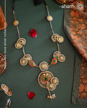 Handcrafted with love this noori dual tone neckpiece is a meticulous mix of royalty and artistry. Shine brighter adorned in this master piece with cultured pearls embellished around silver floral studs with gold polish, paisley  Peacock motifs with deep pink and green spinel, and Kamadhenu (an auspicious sacred cow in the Hindu mythology) motif in the center. Each piece is one of a kind, modern heirloom neckpiece that can be passed on from generations to generations.