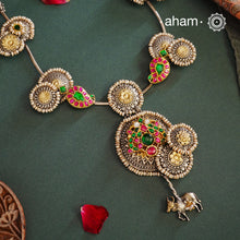 Handcrafted with love this noori dual tone neckpiece is a meticulous mix of royalty and artistry. Shine brighter adorned in this master piece with cultured pearls embellished around silver floral studs with gold polish, paisley  Peacock motifs with deep pink and green spinel, and Kamadhenu (an auspicious sacred cow in the Hindu mythology) motif in the center. Each piece is one of a kind, modern heirloom neckpiece that can be passed on from generations to generations.
