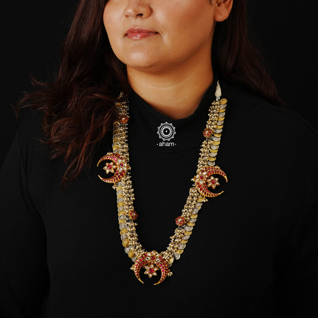 Make a sophisticated style statement with this elegant traditional Kasumala neckpiece. Handcrafted using traditional Kundan Jadua techniques in 92.5 sterling silver with crescent motif and cultured pearls. Perfect for intimate weddings and upcoming festive celebrations.  Kasu Mala is a popular, traditional south Indian neckpiece. The word 'Kasu' means coin, and 'Mala' denotes necklace. The Kasumala is made up of small coins which are so closely strung together that they overlap one another. 