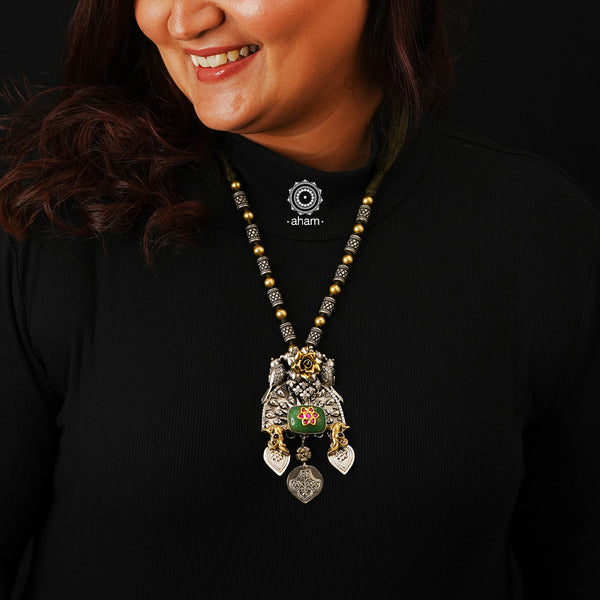 This stunning Two Tone Silver Neckpiece is finely handcrafted with 92.5 sterling silver and features floral Kundan work atop a vibrant green semi-precious stone. Perfect for any ethnic wear, this neckpiece is sure to make a statement.