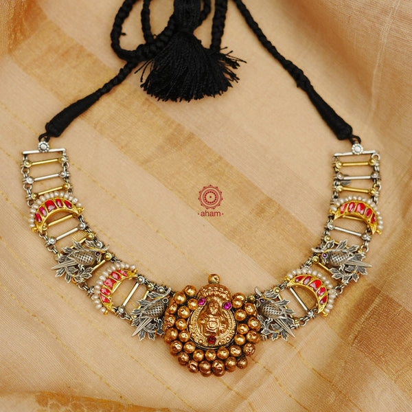 Introducing the Noori Two Tone Silver Neckpiece - a stunning dual tone neckpiece featuring a unique hair ornament from the south as the center piece. Adorned with intricate cuckoo birds and chand motifs, this neckpiece is a true work of art. Elevate your look with this one of a kind piece.
