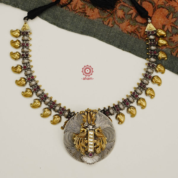 Classic dual tone neckpiece crafted in 92.5 silver with gold highlights, comes with a beautiful double peacock pendant, fine kundan work and the mango mala. Perfect neckpiece to add subtle elegance to your attire. 