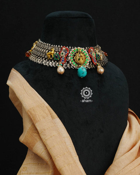 One of a kind statement wearable art pieces. An eclectic mix of elements, with a play of colours, textures, forms and workmanship. Crafted in Silver with two tones that makes this neckpiece so versatile and unique. Intricately detailed 3d peacock takes center stage in this neckpiece, two kundan peacocks on the side, with reindeers and parrots to add to the charm. Modern Heirloom pieces that can be worn across generations.