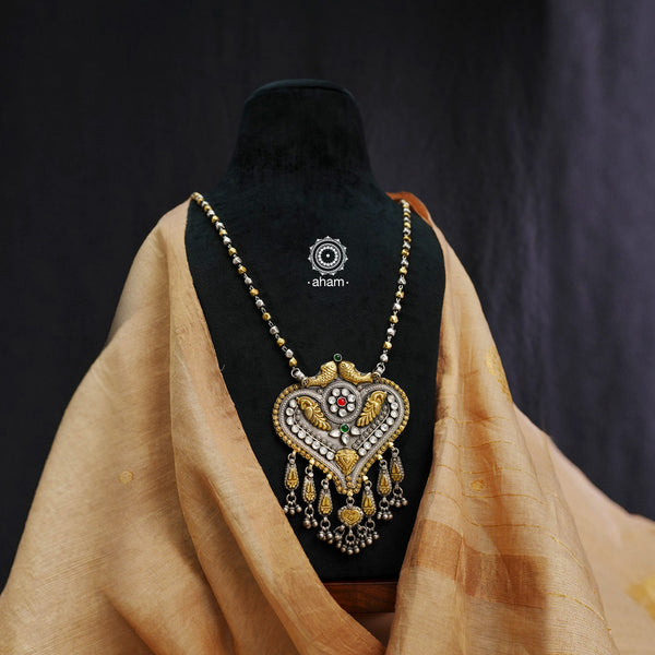 Expertly crafted and designed, the Noori  Neckpiece features a stunning dual-tone design, complete with a elegant Paan-shaped pendant and a delicate kanti mala. Elevate any outfit with this beautiful statement piece.