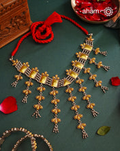 Enhance your style with the timeless elegance of the Dual Tone Silver Choker. Handcrafted by skilled karigars in Barmer, Rajasthan, this neckpiece features traditional Bandhel work, where a thin sheet of hand beaten carat gold is set on 92.5 silver using a unique wax setting technique. A classic representation of fine Indian traditional craftsmanship.