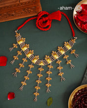 Enhance your style with the timeless elegance of the Dual Tone Silver Choker. Handcrafted by skilled karigars in Barmer, Rajasthan, this neckpiece features traditional Bandhel work, where a thin sheet of hand beaten carat gold is set on 92.5 silver using a unique wax setting technique. A classic representation of fine Indian traditional craftsmanship.