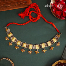 Enhance your style with the timeless elegance of the Two Tone Silver Choker. Handcrafted by skilled karigars in Barmer, Rajasthan, this neckpiece features traditional Bandhel work, where a thin sheet of hand beaten 22 carat gold is set on silver using a unique wax filling technique. A classic representation of Indian craftsmanship.